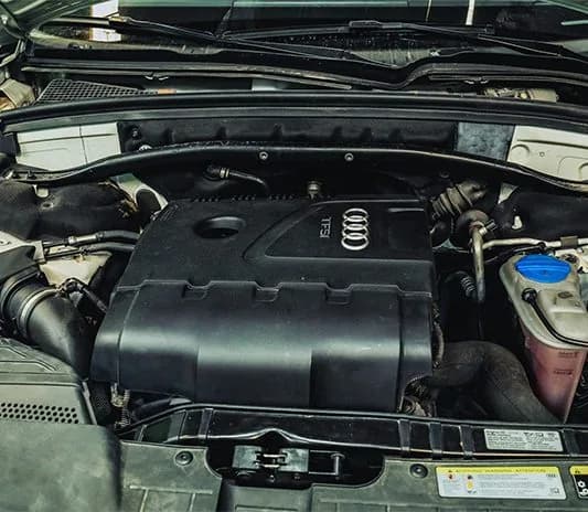 Close-up of an Audi TFSI engine bay during inspection at the Exotic Auto Services workshop
